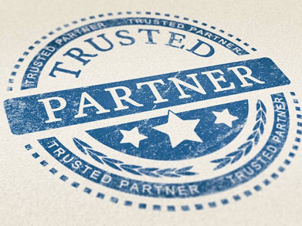 Trusted partner mark imprinted on a paper texture. Concept background for illustration of trust in partnership and business services.